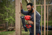 Photo of a person using a Craftsman cordless framing nailer, SKU CMCN621PLB, to fasten wooden studs outdoors.