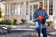 Photo of a person using the Craftsman CMCPW350B cordless power cleaner with soap attachment to wash a car outdoors.