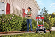 Photo of Craftsman CMEPW2100 pressure washer in use cleaning house siding outdoors.
